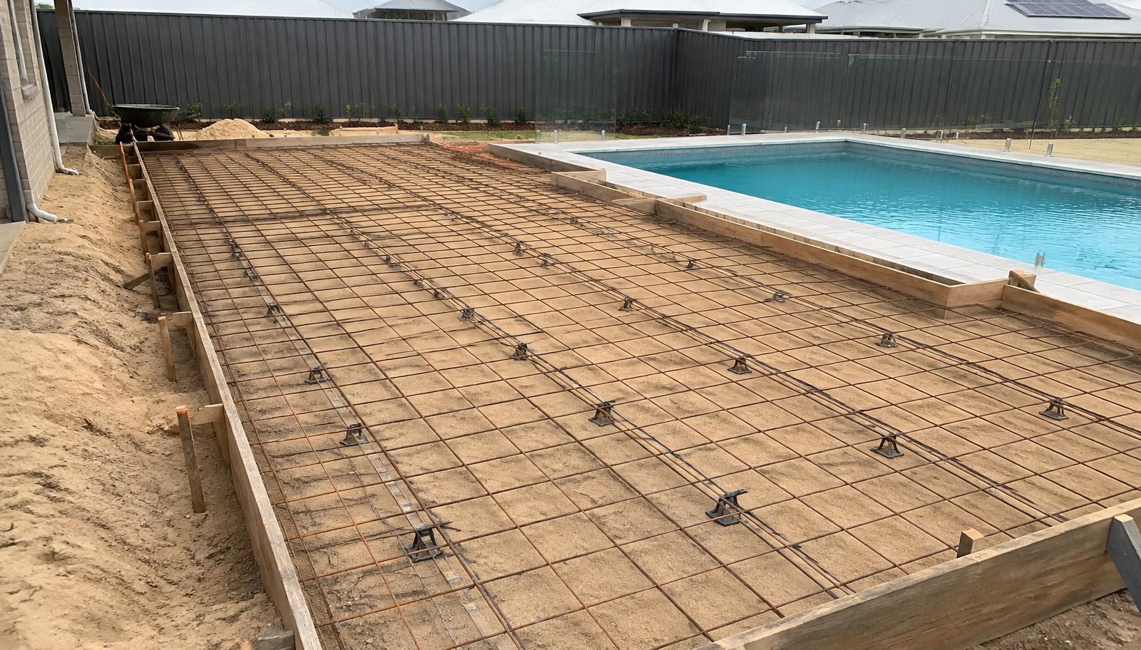 Compacted sandy base, formwork and steel mesh ready for a liquid limestone pool surround pour in Baldivis